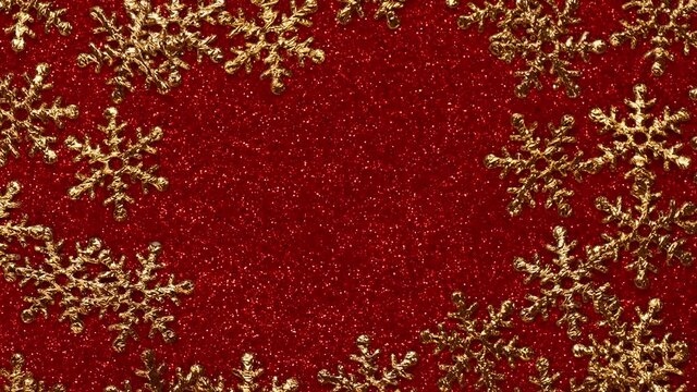 Christmas ornament frame with golden snow flakes on red glitter background