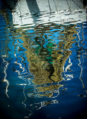 Reflection of fishing boat in the water