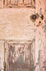 Weathered timber door with pealing and cracked paint