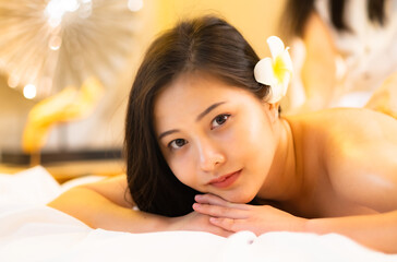 Obraz na płótnie Canvas Asian Beautiful young and healthy woman in spa salon. Massage treatment spa room.Traditional medicine and healing concept.