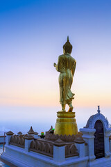 Buddha standing on a mountain Wat Phra That Khao Noi, Nan Province, Thailand
