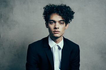 man in black blazer curly hair fashion modern style official