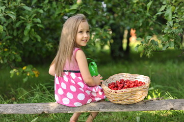 girl with basket of cherries in the garden