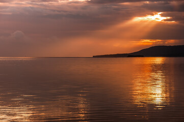 Gorgeous yellow, red dawn, a beautiful beam of sunlight coming out from behind the clouds...