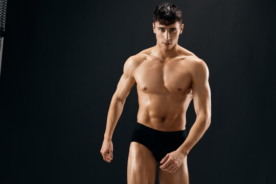 Attractive Athletic Man In Dark Briefs Studio Posing