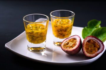 Fresh passion fruit juice in a glass on white plate, Healthy tropical drink