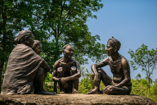 Persons in the woods. Statue of Lachit Borphukan in Jorhat Assam. A memorial honouring General Lachit Borphukan. Near Kaziranga national park, Northeast India.
