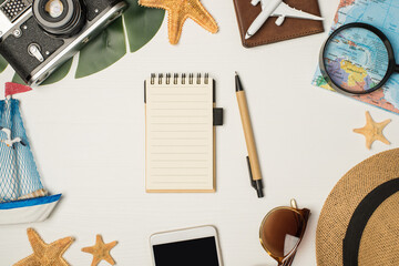 Top view photo of sunglasses sunhat camera map magnifier plane model on passport cover yacht toy smartphone palm leaf starfishes pen and notebook on isolated wooden white background with copyspace