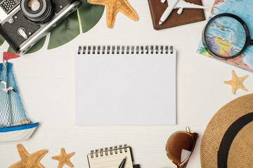 Top view photo of sunglasses hat camera map magnifier plane model on passport cover yacht toy palm leaf starfishes pen copybook and album with copyspace on isolated wooden white background