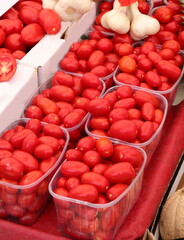 many red ripe tomatoes just picked for sale in the greengrocer s stalls at the vegetable market