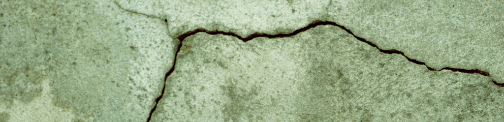 Crack wall texture. Cracked concrete wall covered with cement surface as background. Wall fragment with scratches and cracks