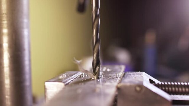 Shot of a drilling machine rotation at the workplace of a toolman locksmith, UHD 4k macro video
