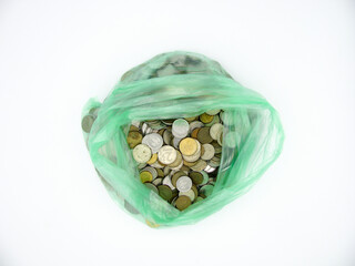 A pile of coins in the currency of the ruble in a transparent package on a white background