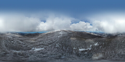 360 degrees photo of the beech forest of the Nebrodi mountains in Sicily during a light snowfall in early spring. View of Etna. Monte Soro and the Aeolian Islands with the Tyrrhenian Sea. 