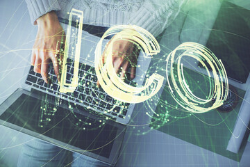 Double exposure of woman hands working on computer and blockchain theme hologram drawing. Top View. bitcoin cryptocurrency concept.
