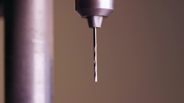 Slider pan shot of a drilling machine rotation at the workplace of a toolman locksmith