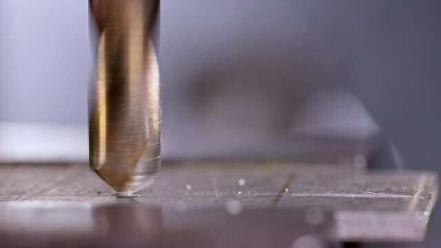 Shot of a drilling machine rotation at the workplace of a toolman locksmith, UHD 4k macro video