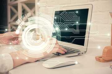 Double exposure of woman hands working on computer and data theme hologram drawing. Tech concept.