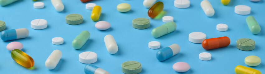 Unsorted pharmaceutical preparations on a blue background banner