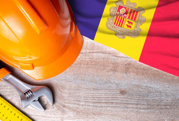 Andorra flag with different construction tools on wood background, with copy space for text. Happy Labor day concept.
