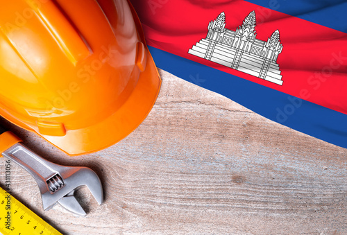 Cambodia flag with different construction tools on wood background, with copy space for text. Happy Labor day concept.