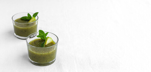 Homemade vegetable green smoothie with apple, cucumber, mint and lime