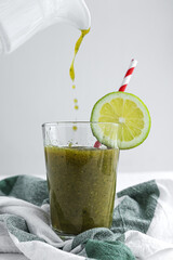 Homemade vegetable green smoothie with apple, cucumber, mint and lime