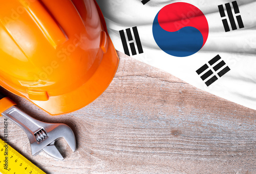 South Korea flag with different construction tools on wood background, with copy space for text. Happy Labor day concept.