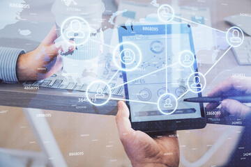 Double exposure of man's hands holding and using a phone and social network theme drawing.