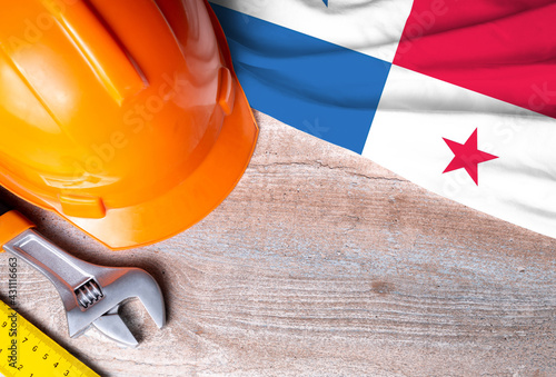 Panama flag with different construction tools on wood background, with copy space for text. Happy Labor day concept.