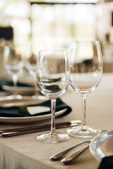 Luxurious restaurant. Luxurious interior, white tables, serving dishes and glasses for guests