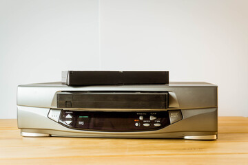 VHS player, recorder with a tape introduced and a tape on top