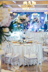 A beautiful vase of flowers on a table in a luxury restaurant. Wedding decorations