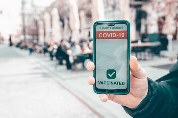 Person at the resturant using mobile app in phone to show immunization certificate.
