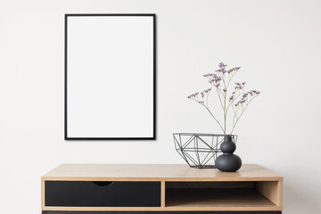 Blank picture frame mockup in interior design. Living room, table with and vase. View of modern scandinavian style interior with artwork template on a white wall. Home workplace