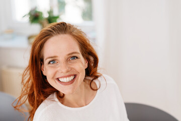 Motivated young woman with a beaming toothy smile
