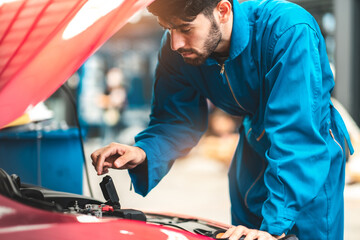 Car Mechanic Ready For Work. Auto Mechanic with Large Wrench in Hands. Ideas How to Fix the Problem.Male mechanics at the garage fixing a car.Closed up focus .