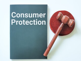 Top view gavel with black book written consumer protection.