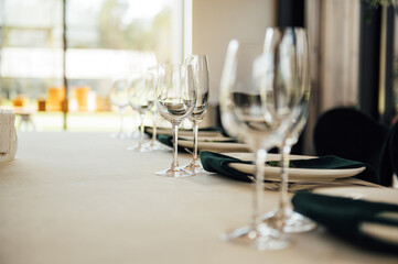 Luxurious restaurant. Luxurious interior, white tables, serving dishes and glasses for guests