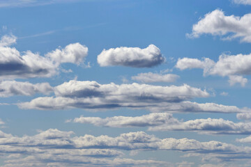 White cumulus clouds on a blue sky