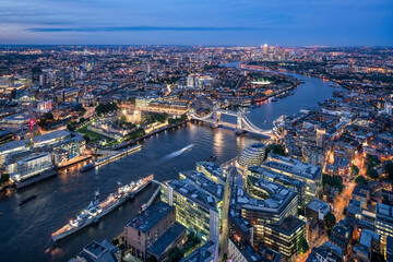 Aerial view of London at night with Thames River and Tower Bridge