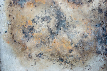 Abstract background of rusty damaged and dirty metallic plate with scratches, cracks and colorful stains. Plain and rich texture of grungy tinware.