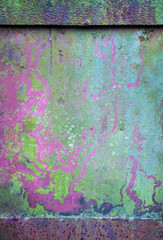 Abstract background of rusty damaged and dirty metallic plate with scratches, cracks and colorful stains. Plain and rich texture of grungy tinware.