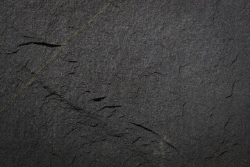Rough cave stone wall surface with natural cracks used for background.