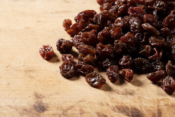 Raisins on an old wooden background.