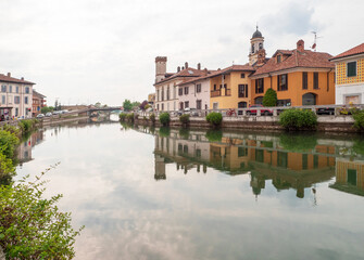 Fototapeta na wymiar cityscape of Gaggiano, village near Milan crossed by the navigable canal called Naviglio Grande on a cloudy day.Lombardy,Italy.