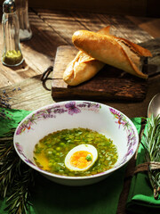 vegetable soup with bread baguette on a plate