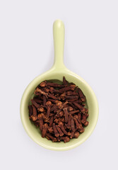 Small trial portion of dry cloves on platter isolated on white background. Design element with clipping path