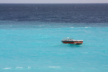 small boat in the azure water. Sunny day, beautiful sea and summer vibes.