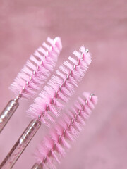 Three pink brushes for lashes and eyebrows macro view 